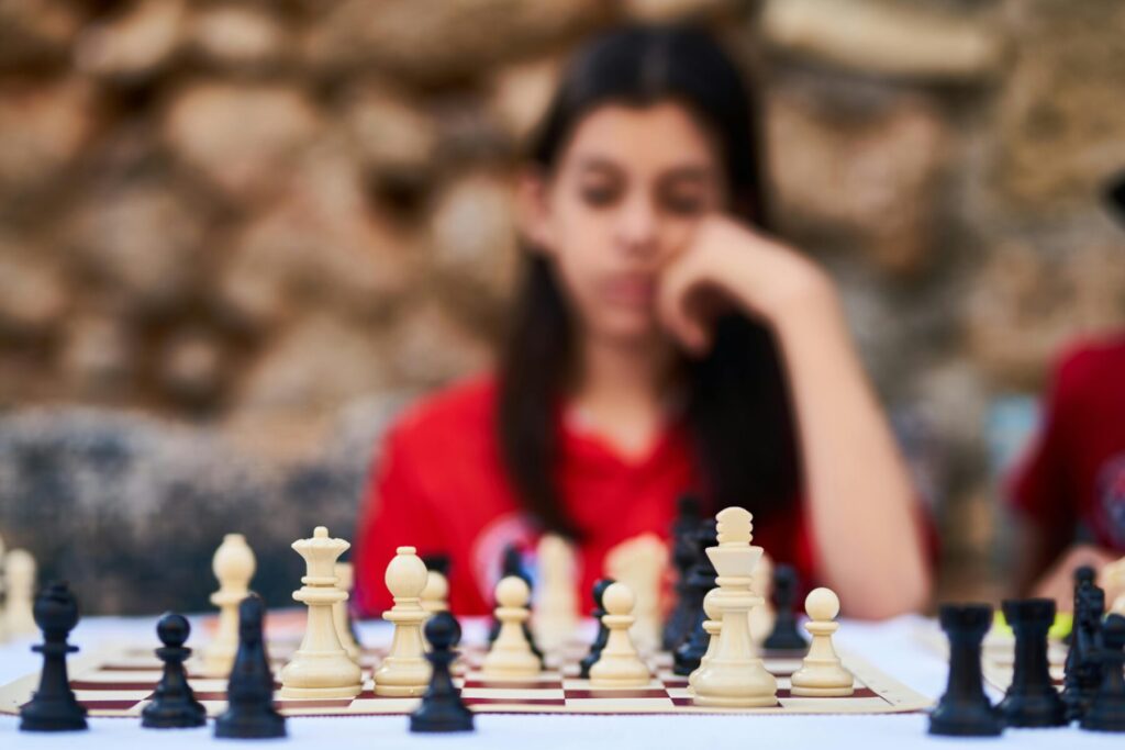 child learning chess with guidance showing personalized coaching support