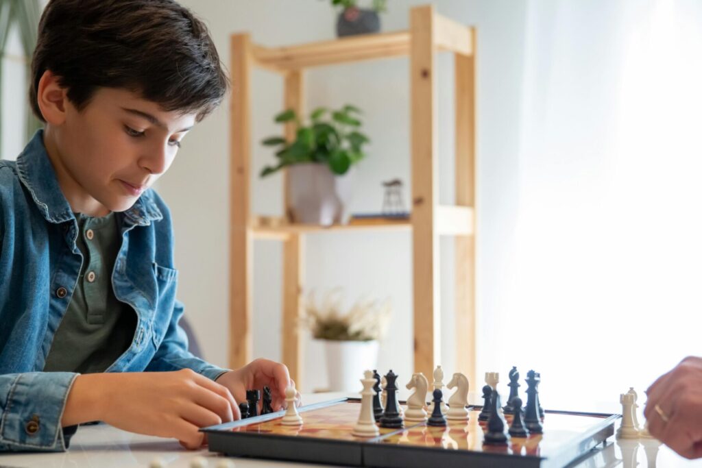 child concentrating while playing chess developing focus and thinking skills