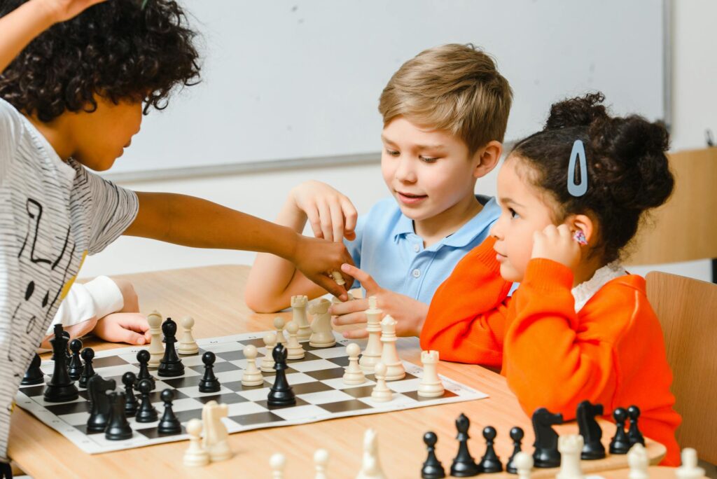 young child learning chess pieces and basic moves on board
